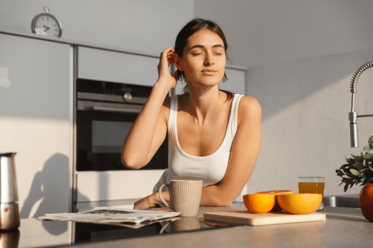 featured image in Why You Absolutely NEED A Morning Routine ASAP showing a woman enjoying the morning sun