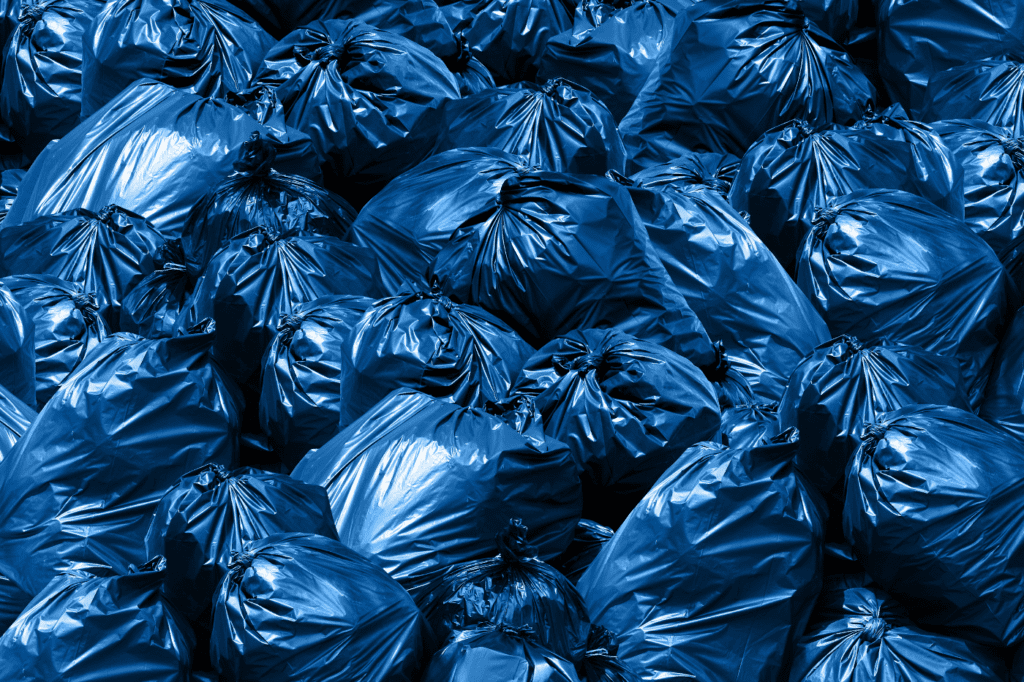 featured image in How to: Minimize Waste (Zero Waste Living Guide 2024) showing trash bags