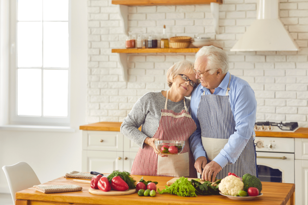 featured image for a blog post called Sustainable Cookware: 7 Reasons Why You Definitely Need It, showing an elderly couple cooking healthy food together