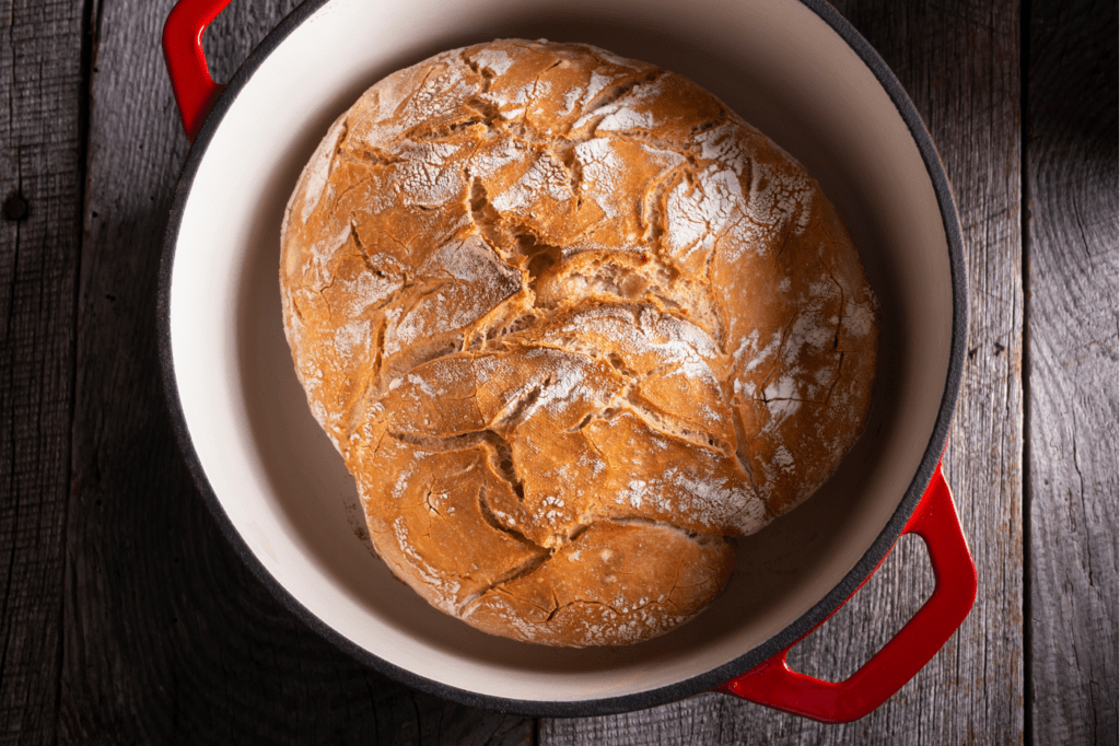 featured image for a blog post called Sustainable Cookware: 7 Reasons Why You Definitely Need It, showing a dutch oven with bread in it