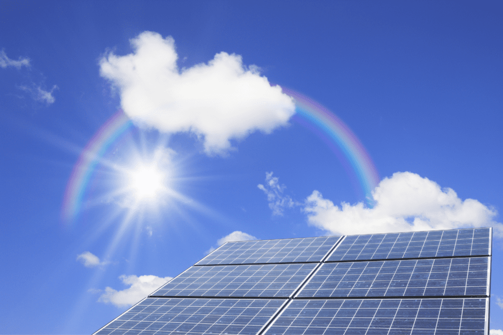 image showing a solar panel with a clear sky and a rainbow