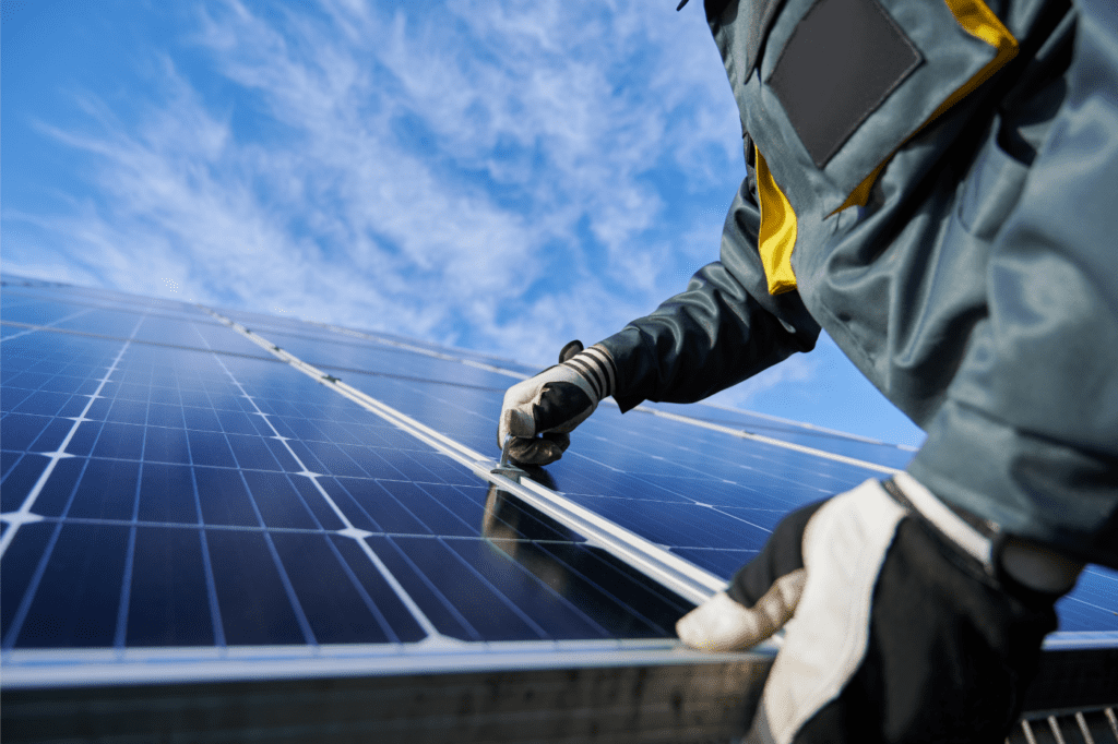 image showing a man installing solar panels