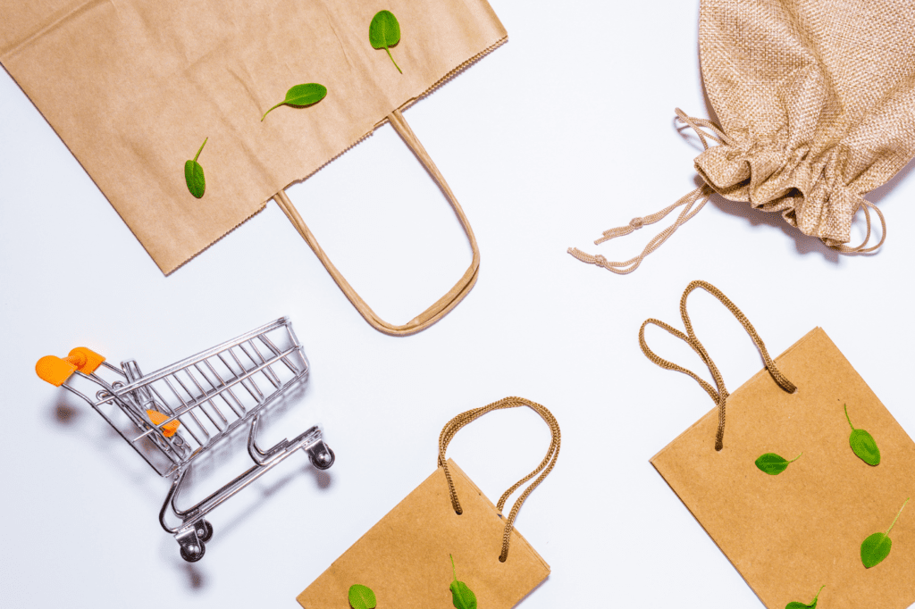 image showing a shopping cart and shopping bags with leafs on them