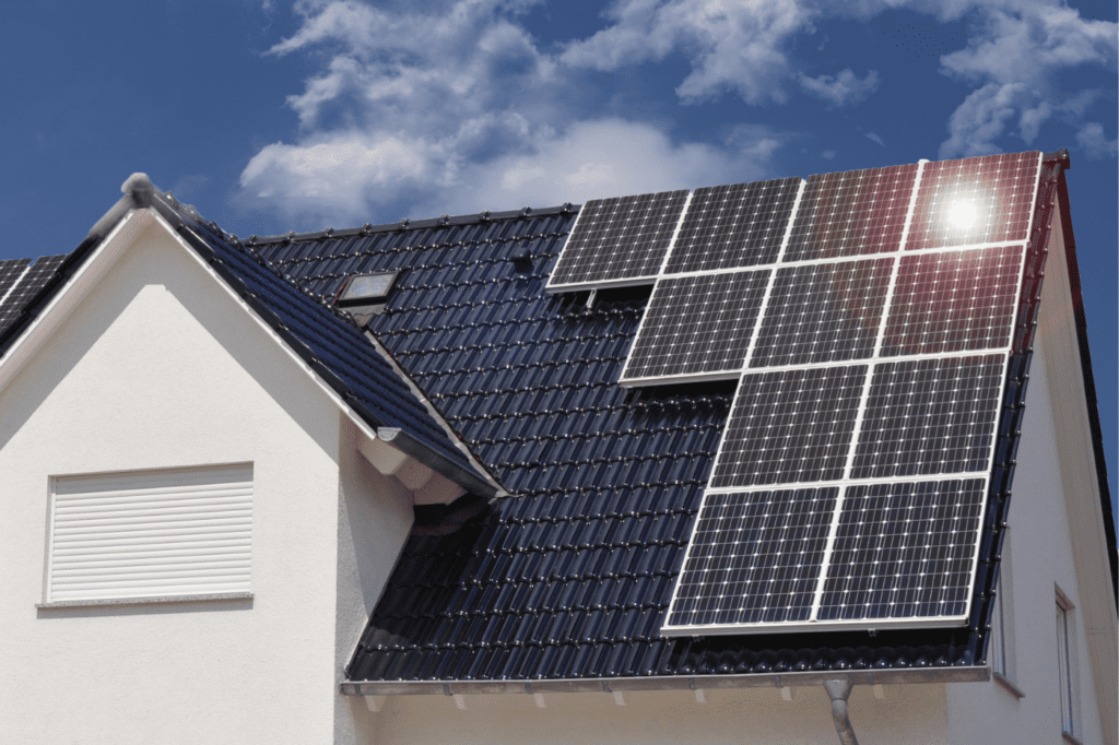 image showing a roof with black solar panels