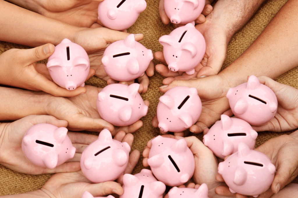 a lot of people holding their piggy banks together